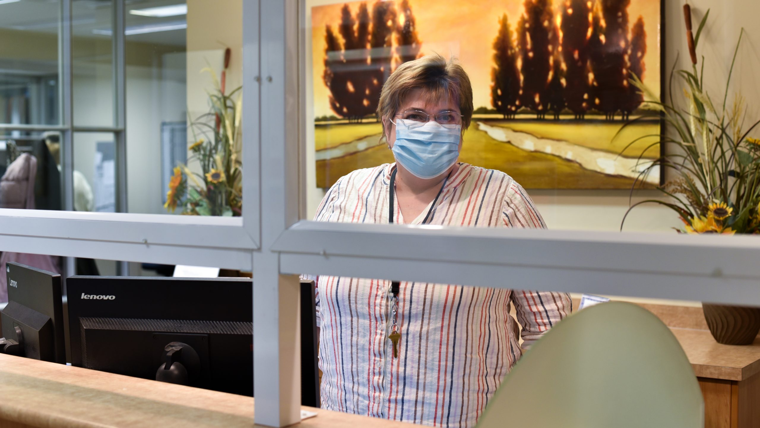 Regina Office front desk with mask and sheild Nora