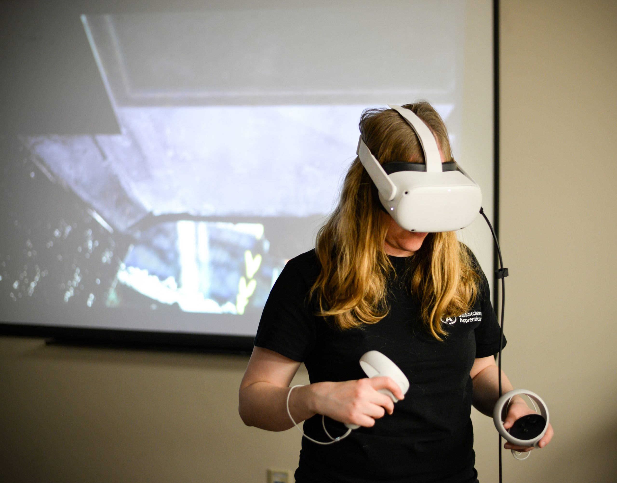 Woman wearing VR headset and holding VR controllers